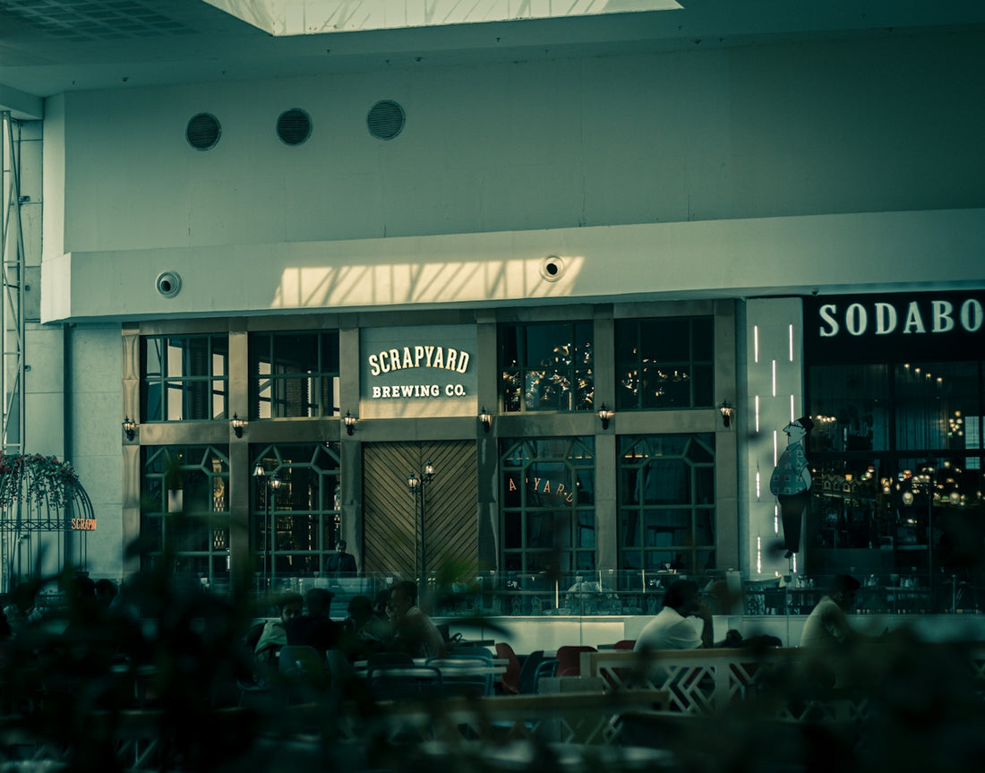a restaurant with people sitting at tables outside