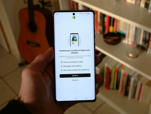 A phone shows a shopify app setup screen.